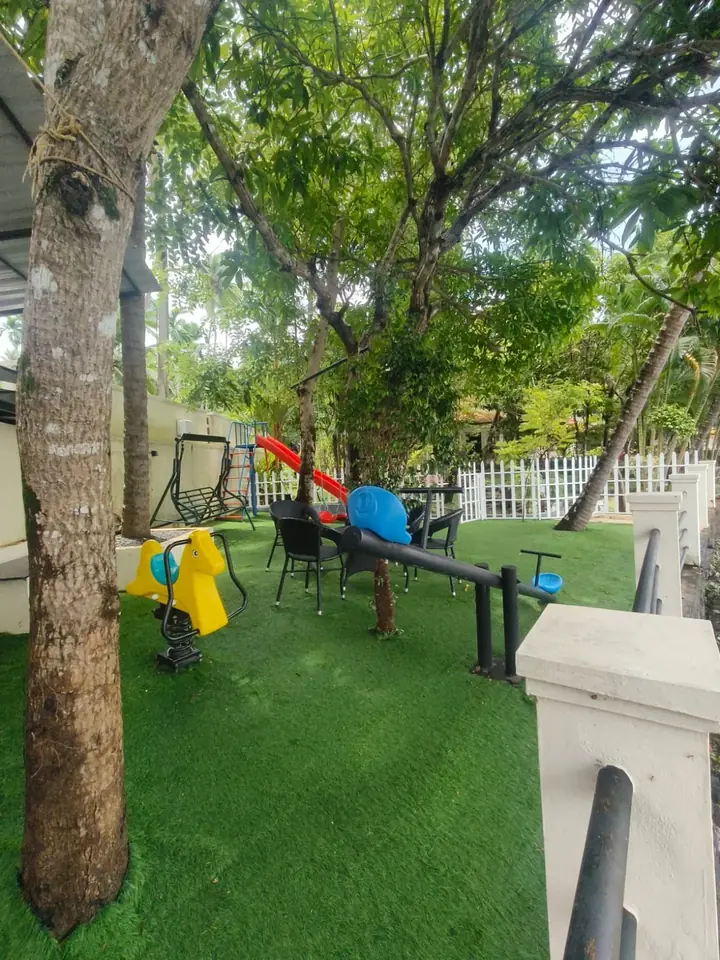 Slide, swing and spring rider on the lawn, BelleVue Riverside Villa, Kozhikode