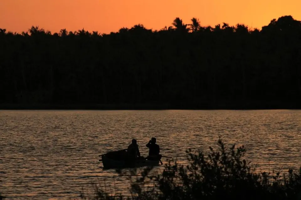 A canoe at sunset on the river, BelleVue Riverside Villa, Kozhikode