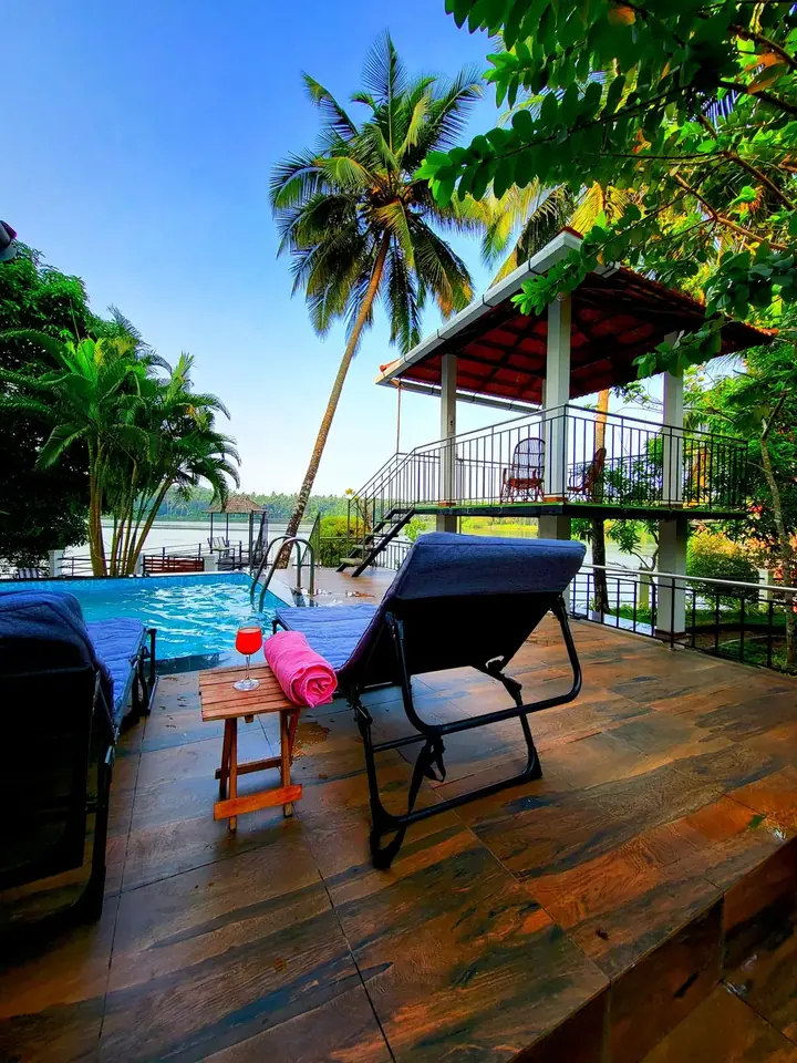 Loungers facing the river, BelleVue Riverside Villa, Kozhikode