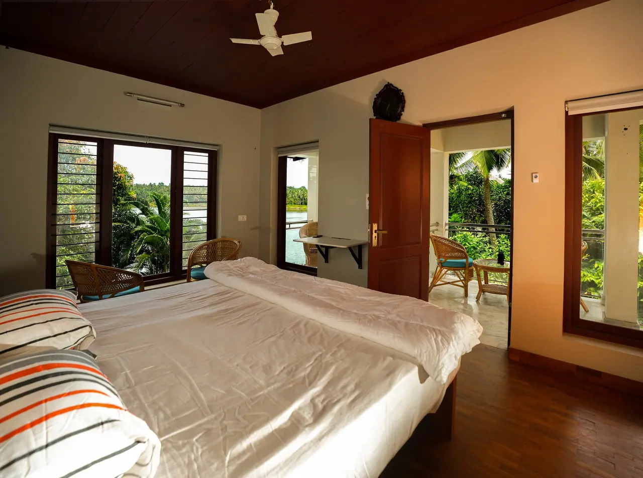 Riverside Bliss Suite at BelleVue with the Korapuzha river visible through the open balcony door