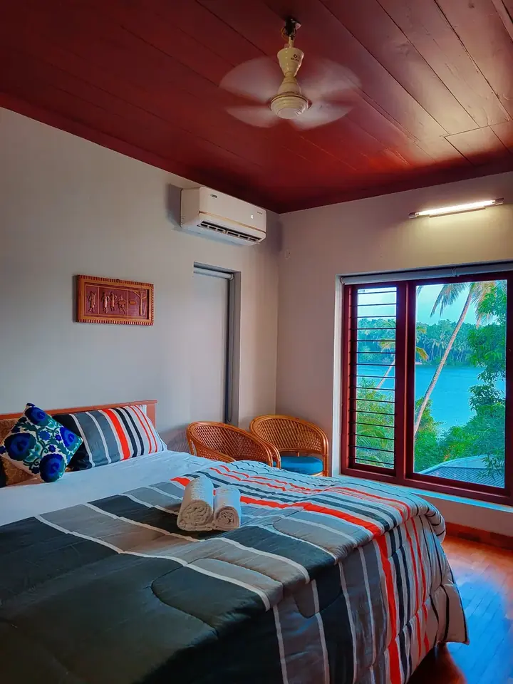 A room with a river-view window, BelleVue Riverside Villa, Kozhikode