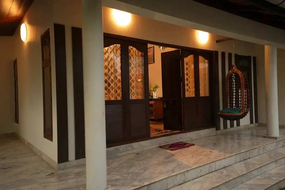 Wooden doors onto the veranda, BelleVue Riverside Villa, Kozhikode